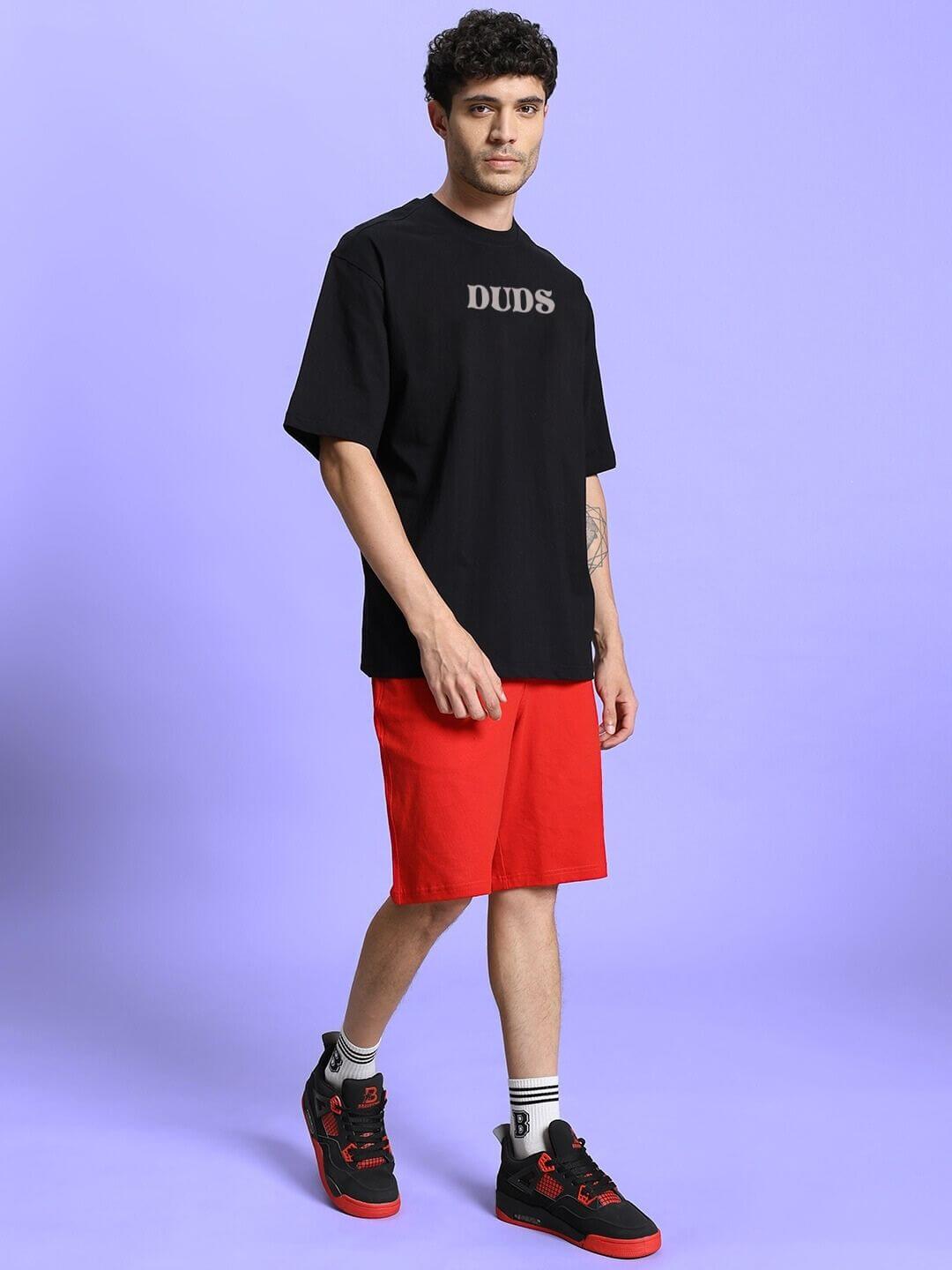 Casual streetwear outfit with black T-shirt and red shorts, perfect for a stylish and relaxed look.