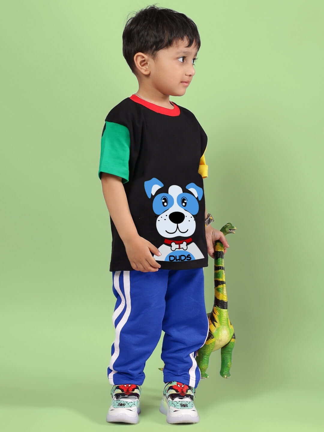 Child wearing a black and blue puppy dog printed co-ord set with toy, made by DUDS.