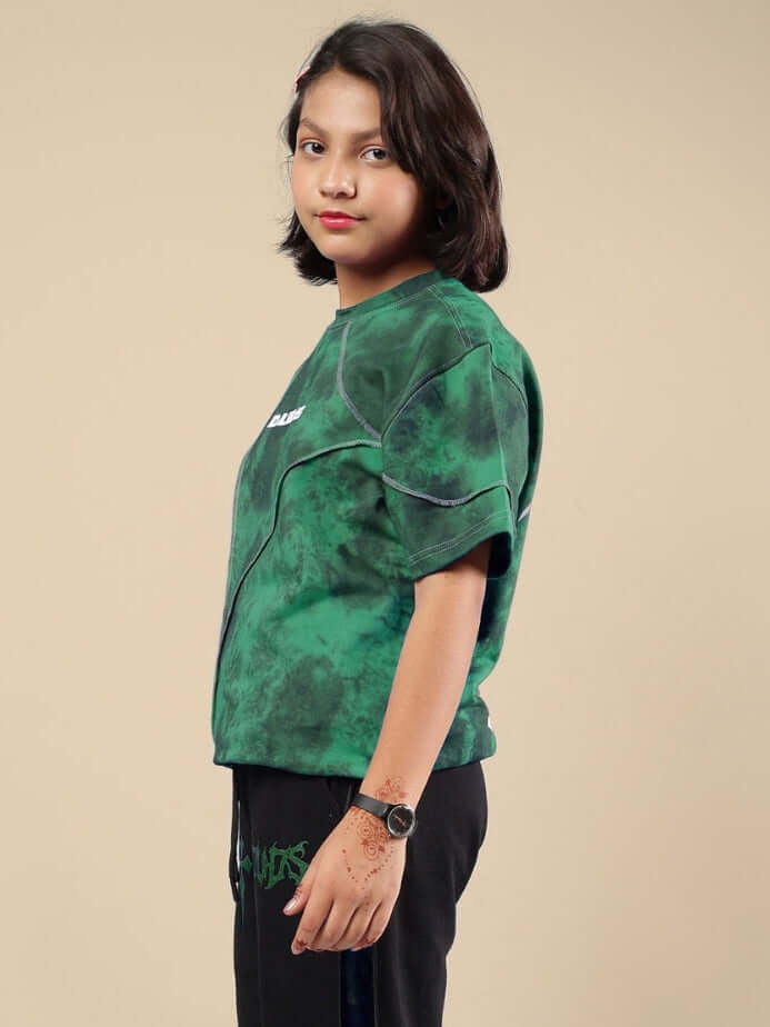 Child wearing green Ghost Rider tie-dye t-shirt, side view showcasing fit and color. Ideal for boys and girls.