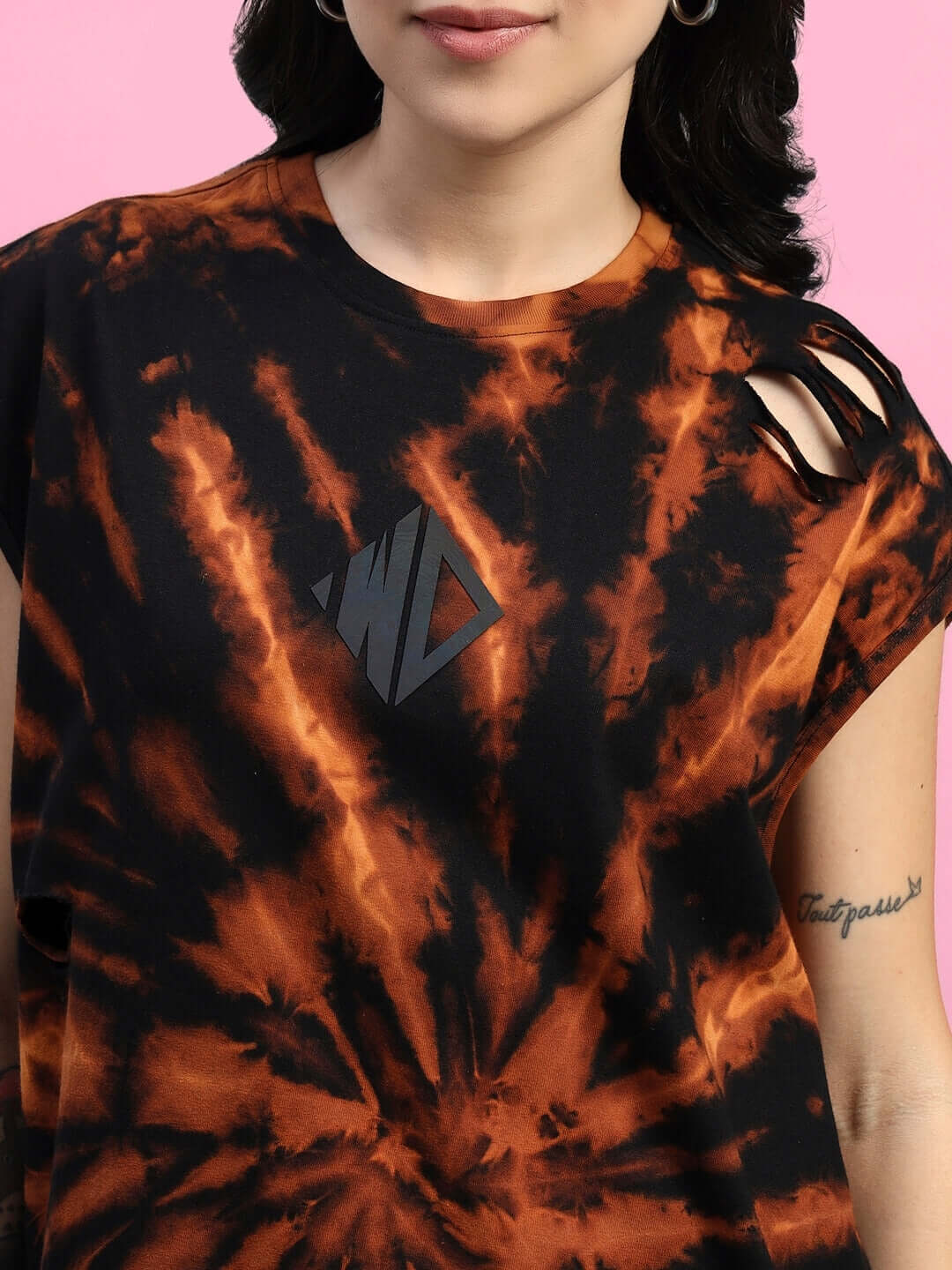 Woman wearing black and orange tie-dye ripped muscle tee co-ord set made of premium cotton, showcasing stylish design details.