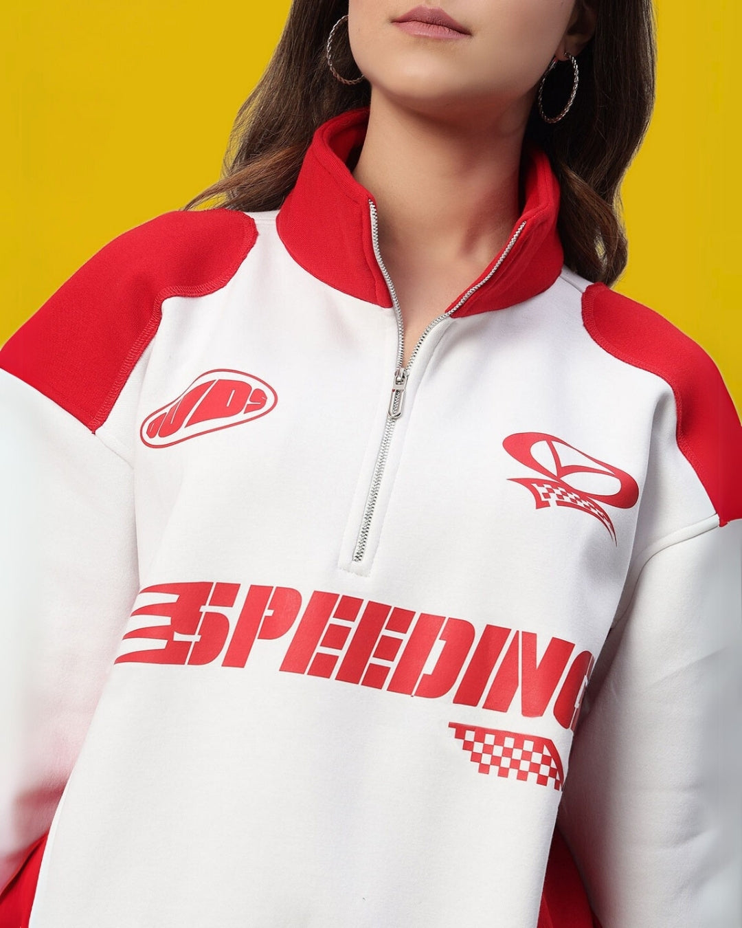 Women's colorblock jacket in red and white with graphics, featuring a half-zip design against a yellow background.