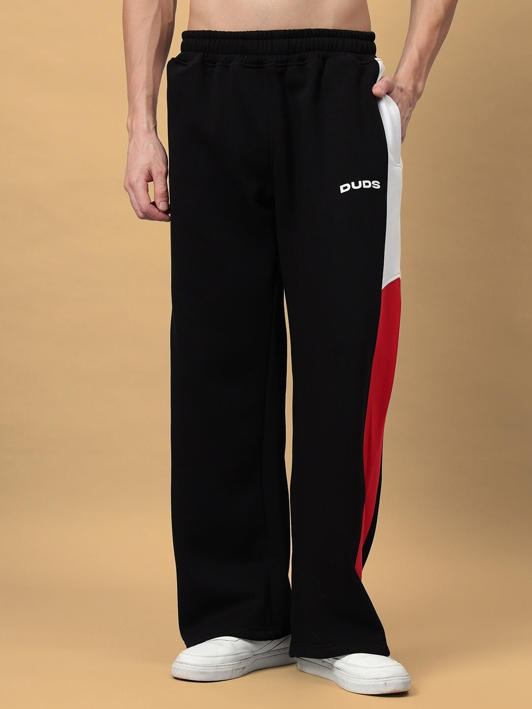 Black fleece colorblock co-ord pants with red and white accents, relaxed fit, and elastic waistband.
