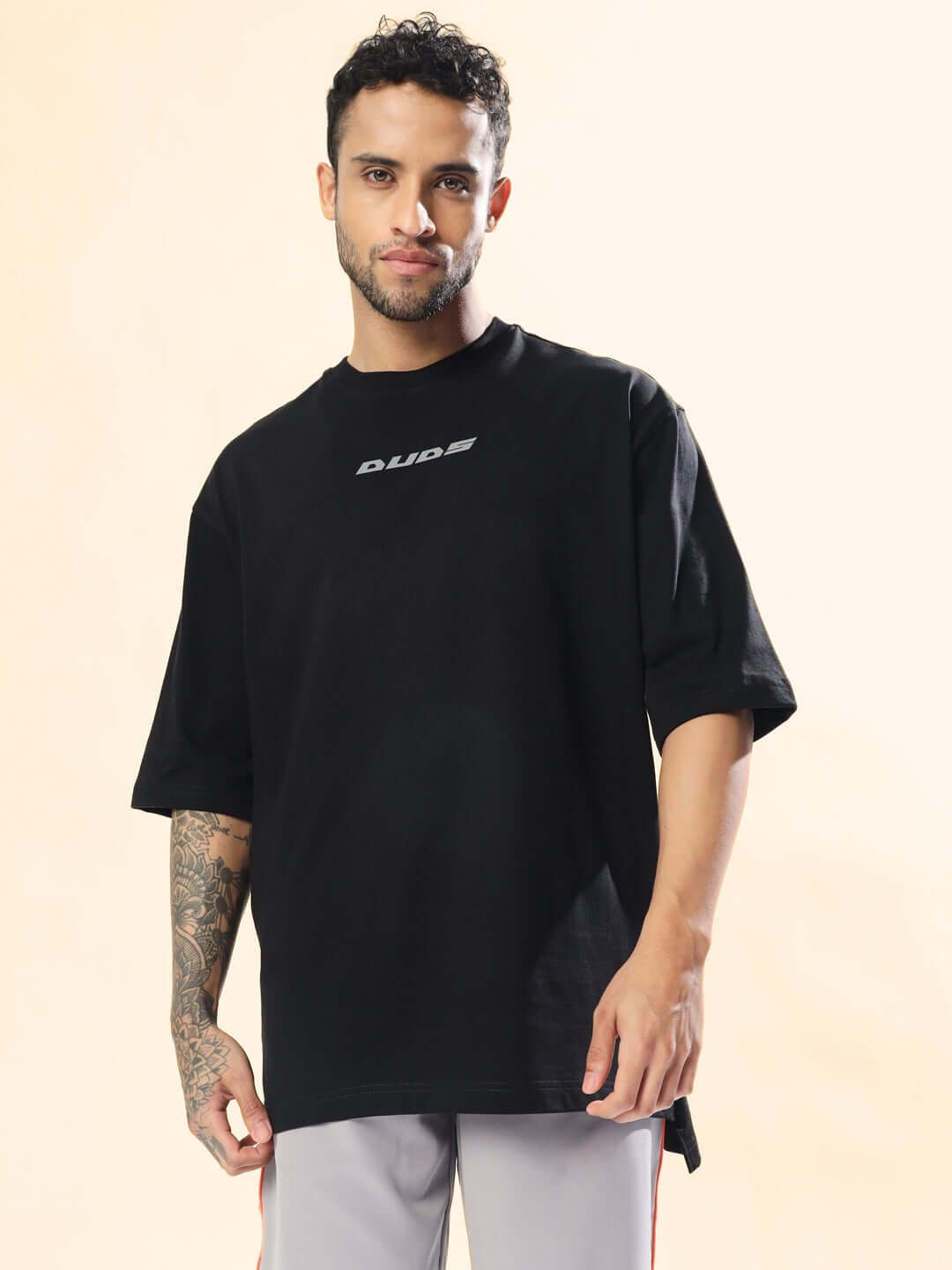 Model wearing SCORPIO ZODIAC LONGLINE OVER-SIZED T-SHIRT BLACK, showcasing stylish casual wear.