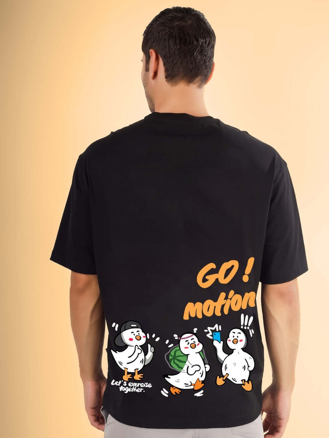 GO MOTION OVER-SIZED T-SHIRT BLACK with cartoon graphics on back view.
