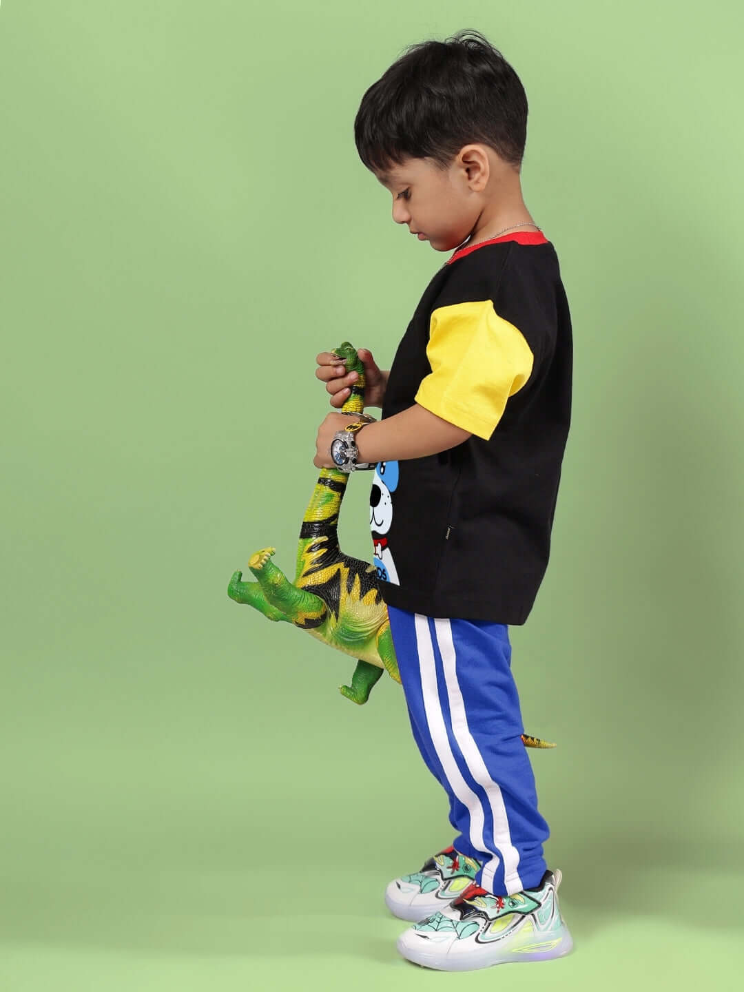 Child wearing Puppy Dog Printed Co-ord in Black and Blue, holding a toy dinosaur, suitable for boys and girls.
