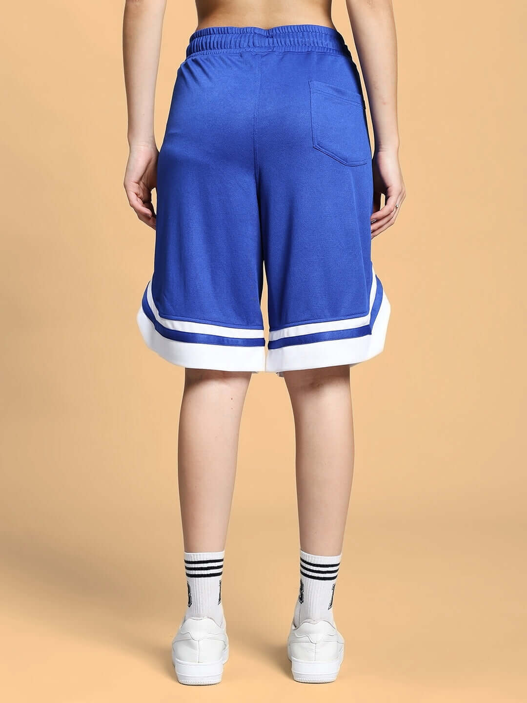 Back view of women's royal blue shorts with white trim, showcasing regular fit design and comfortable waistband.