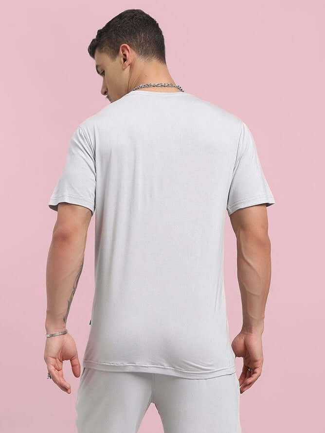 Rear view of a model wearing the AMBLE grey t-shirt made from premium heavy gauge modal fabric, highlighting the soft material.