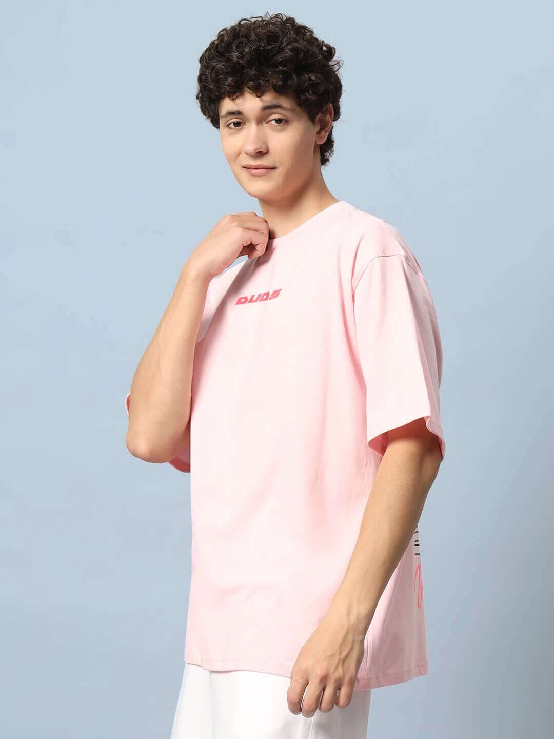 Male model wearing DYING GOD OVER-SIZED T-SHIRT PINK from DUDS