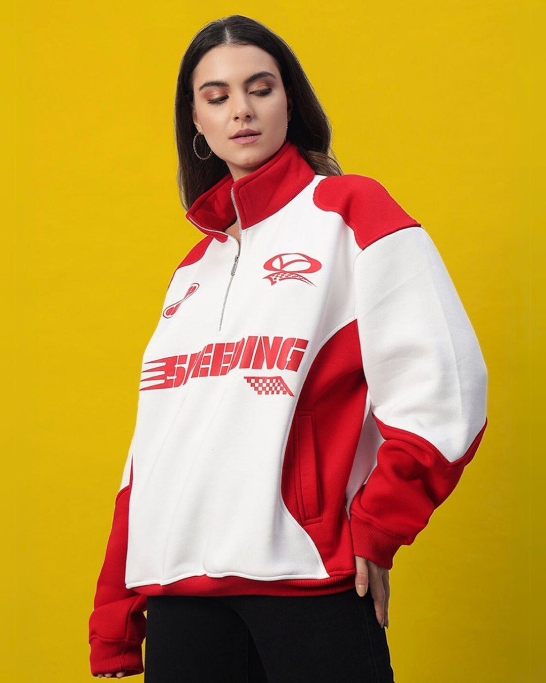 Women's red and white colorblock jacket with modern design, worn by a model against a yellow background.