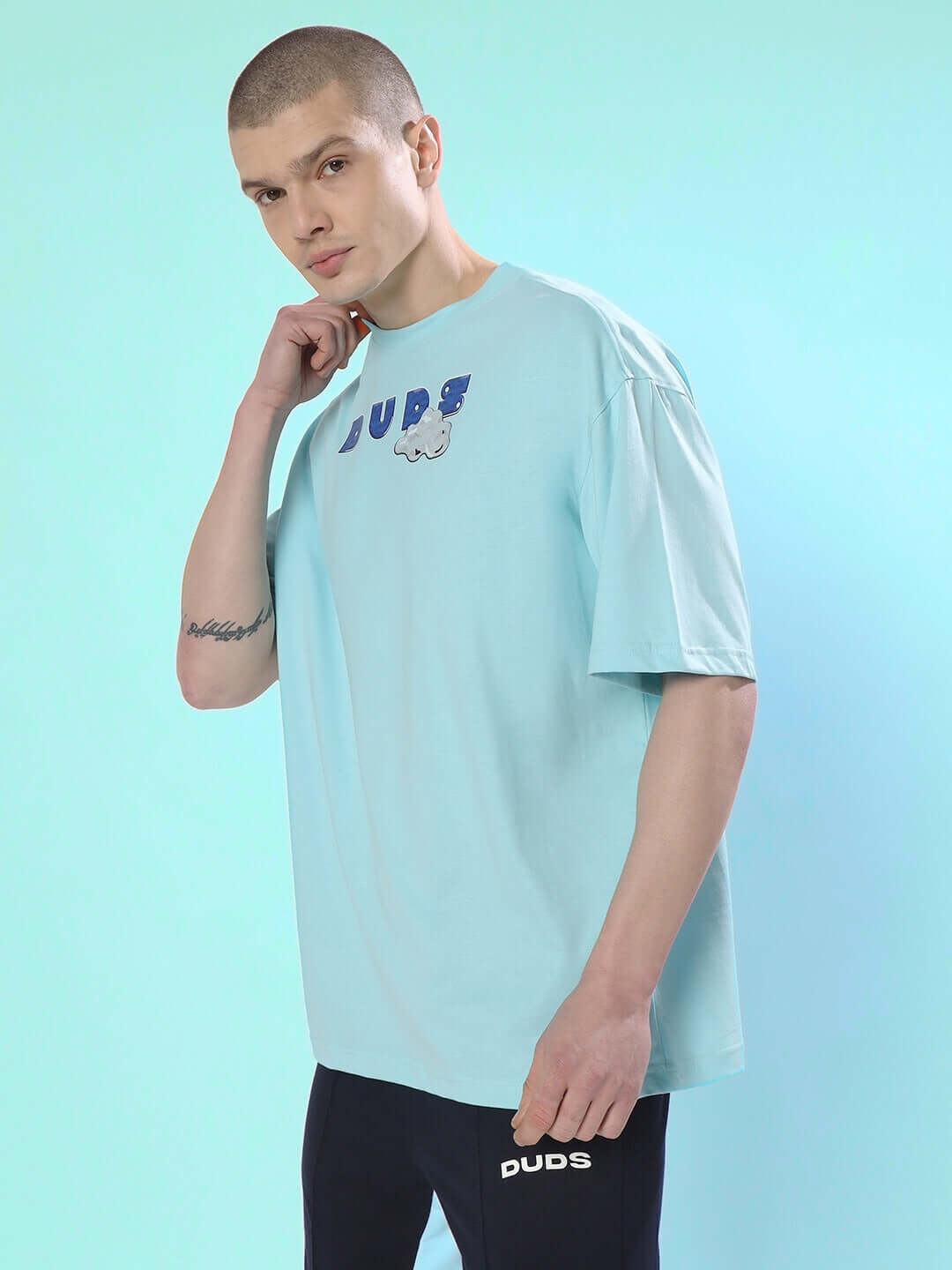 DUDS CREATIVE OVER-SIZED T-SHIRT SKY BLUE on model, made with premium 100% cotton fabric.