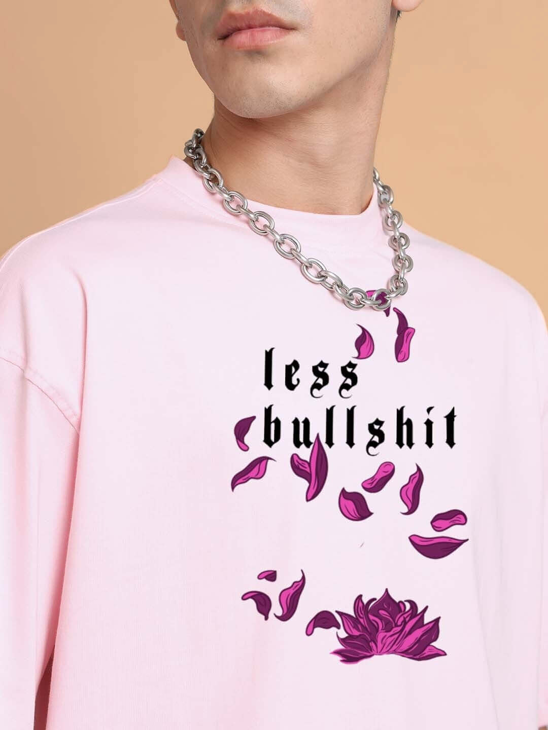 MOANING TIGRESS OVER-SIZED T-SHIRT PINK with floral graphic and text "less bullshit," worn by model with silver chain necklace.