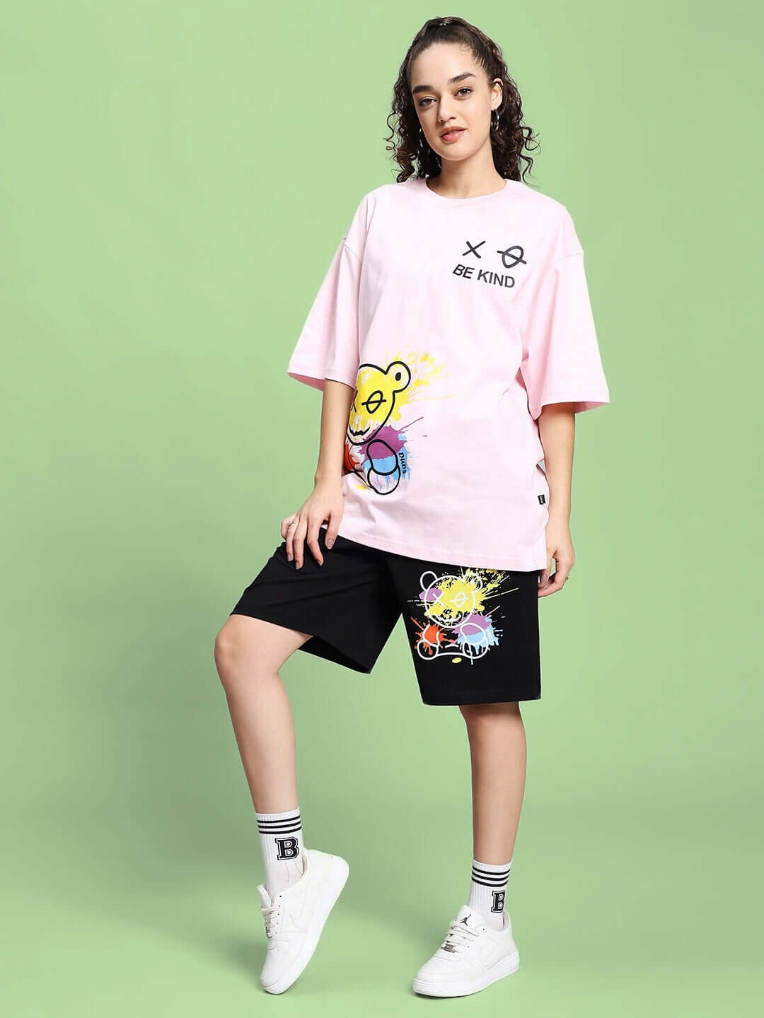 Woman modeling the Be Kind pink-black summer co-ord set with vibrant cartoon graphics, featuring a premium cotton blend.
