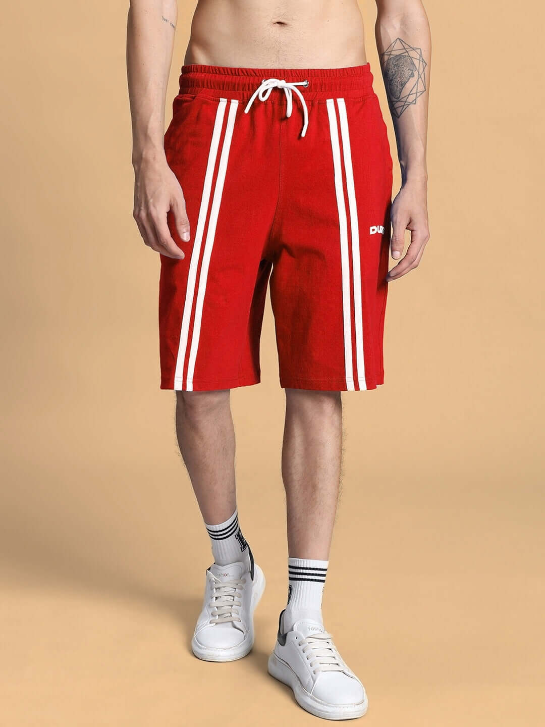 Red summer co-ord shorts set with white stripes, crafted from premium cotton and elastane, shown on model from the front.
