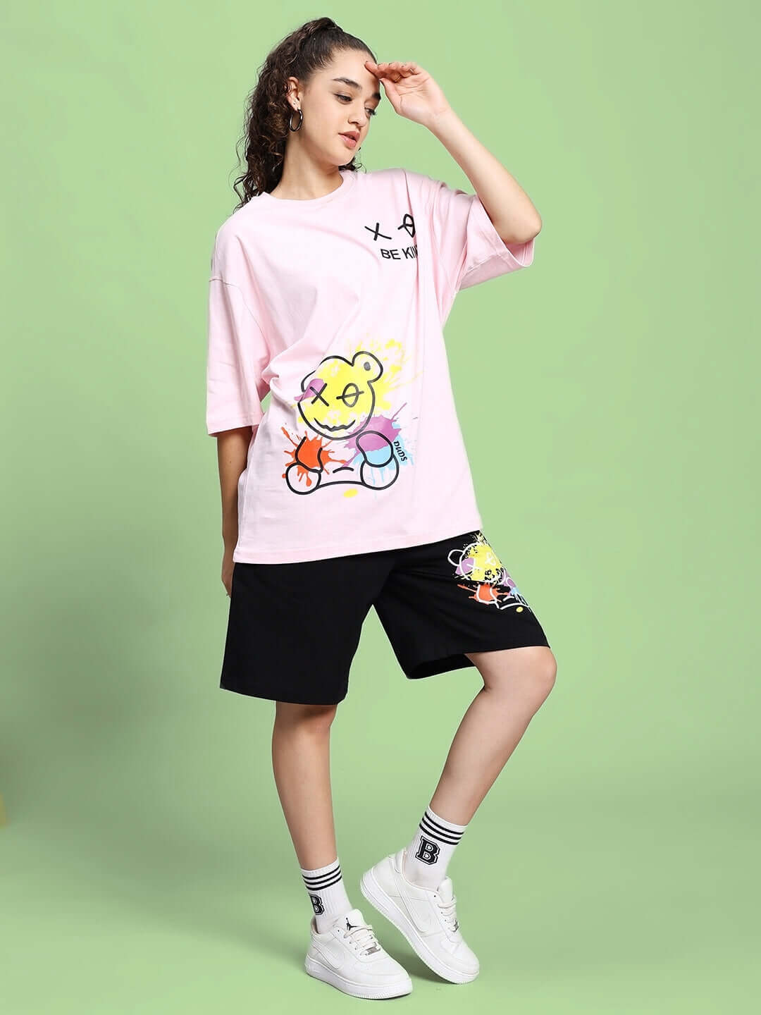 Woman modeling Women's Be Kind Summer Co-Ord Set in pink-black; features premium cotton French terry, cartoon print, ideal for casual wear.