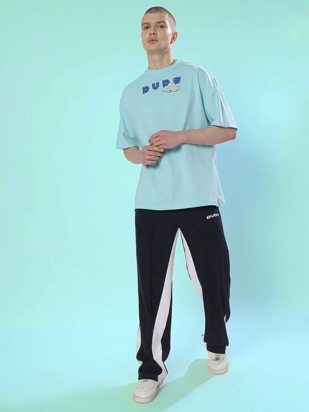 DUDS CREATIVE OVER-SIZED T-SHIRT SKY BLUE worn by a model, made from premium heavy gauge 100% cotton, showcasing casual fashion.