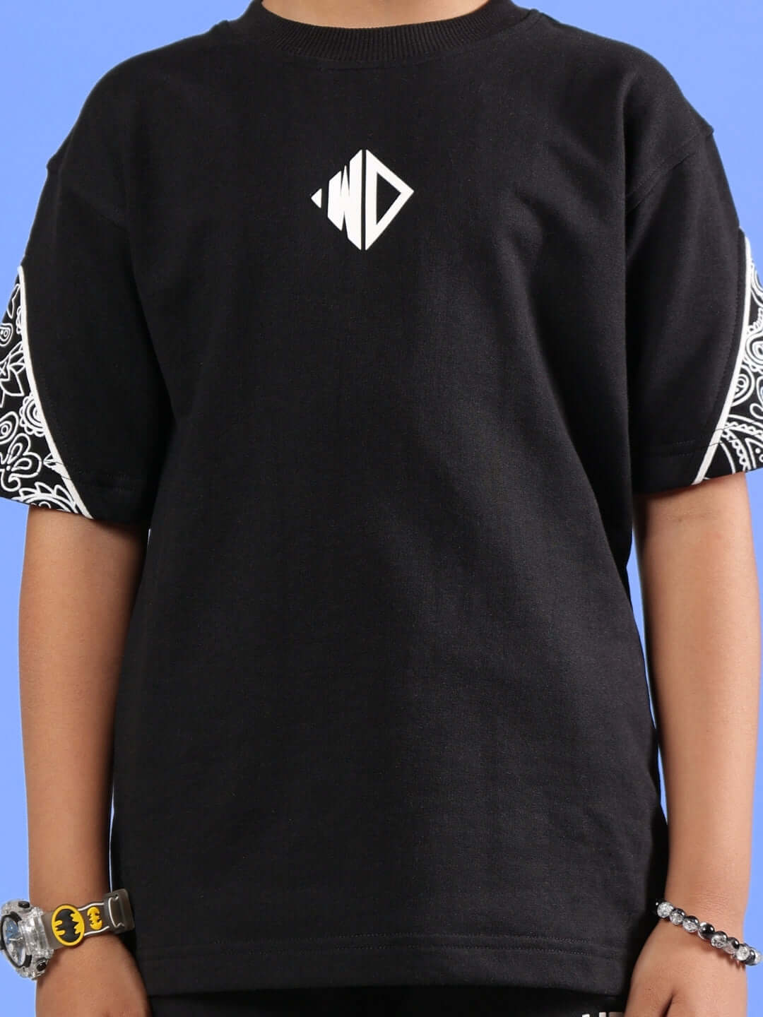 Black oversized CALVIN t-shirt for kids, featuring unique sleeve patterns and a central logo, crafted by DUDS.