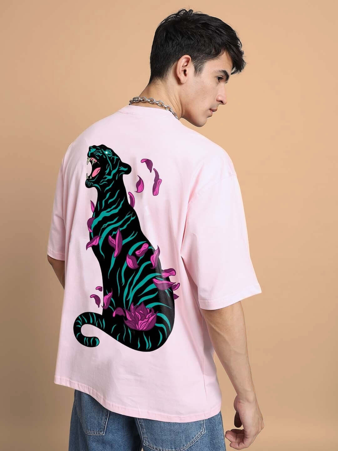 Model wearing MOANING TIGRESS OVER-SIZED T-SHIRT PINK with tiger design on back, showcasing custom fit option.