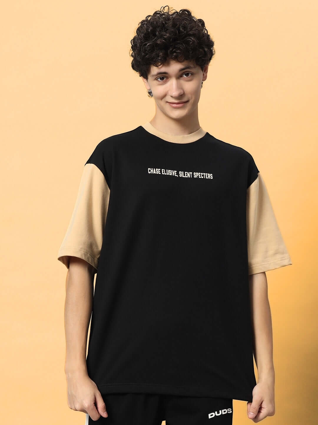 PHANTOM OVER-SIZED T-SHIRT BLACK BEIGE worn by model showcasing a stylish two-tone design with "Phantom" graphic.