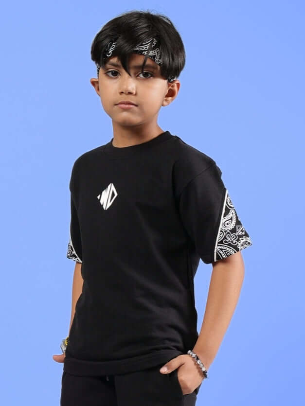 Boy wearing black CALVIN oversized t-shirt with patterned sleeves, suitable for both boys and girls, available for custom fit.
