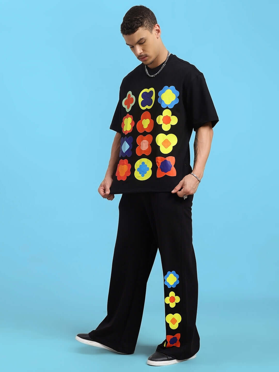 Model wearing black HOLLISTER tie-dye co-ord set with colorful flower patterns, featuring premium cotton fabric and comfortable fit.