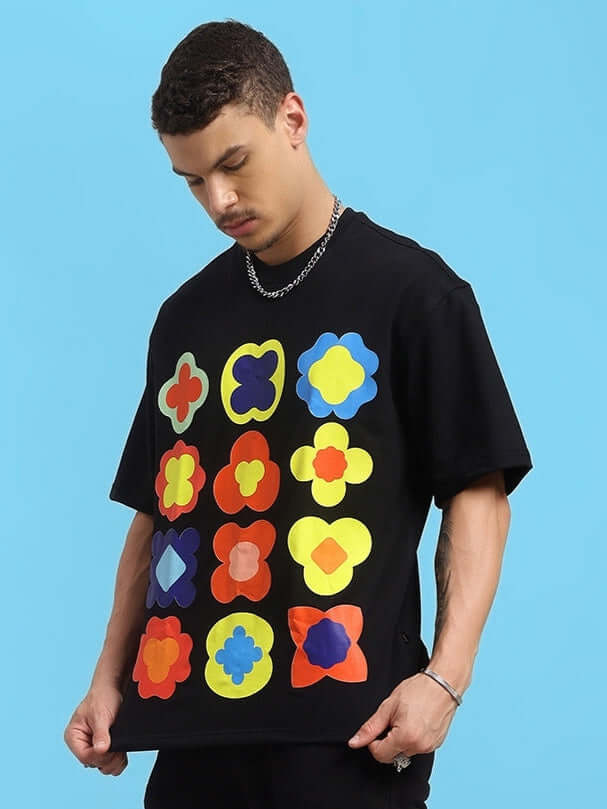 Model wearing Hollister over-sized black t-shirt with colorful geometric patterns, made of premium cotton blend fabric.