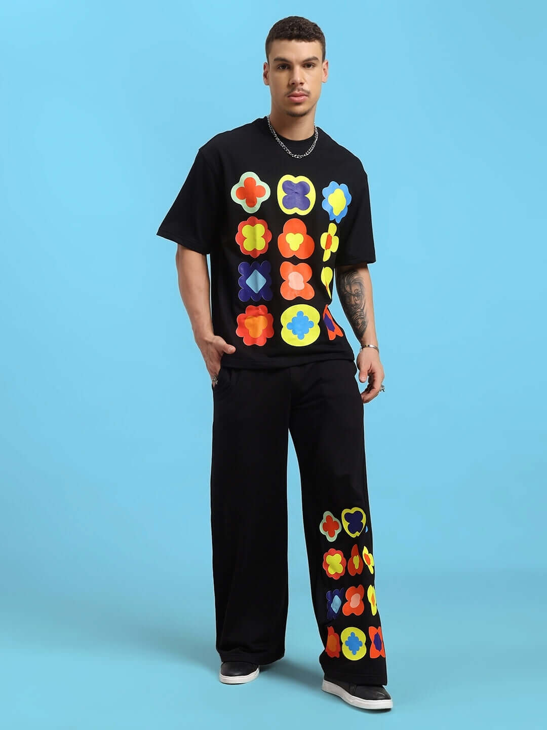 Model wearing a black tie-dye co-ord set with colorful patterns, made of premium cotton French terry lycra.