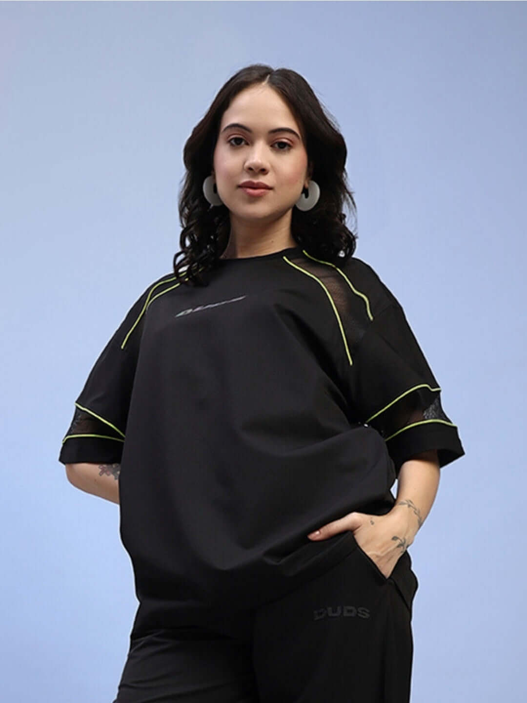 Woman wearing a women's black Salvo regular fit T-shirt made from sports polyester fabric, featuring stylish design and comfortable fit.