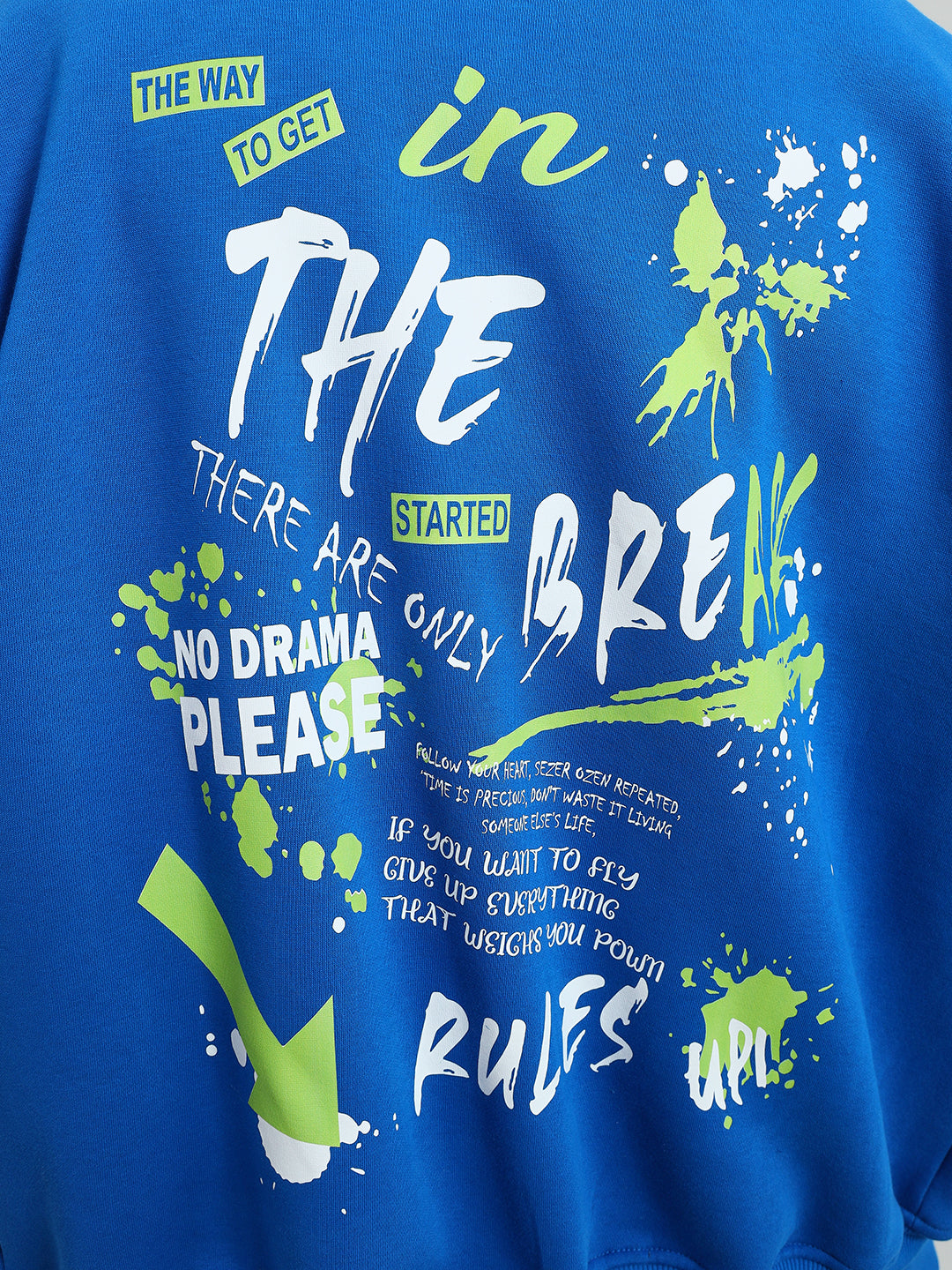 Royal blue fleece with abstract text design featuring green and white graphics reading 'No Drama Please'.