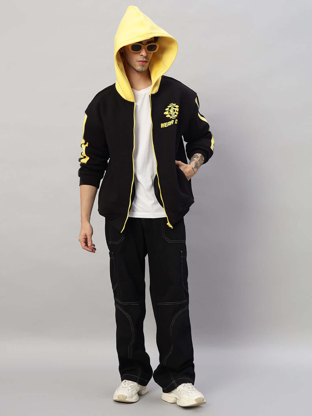 Model wearing Cruiser Fleece Colorblock Hoodie in black and yellow with hood up, featuring stylish streetwear look and casual vibe.