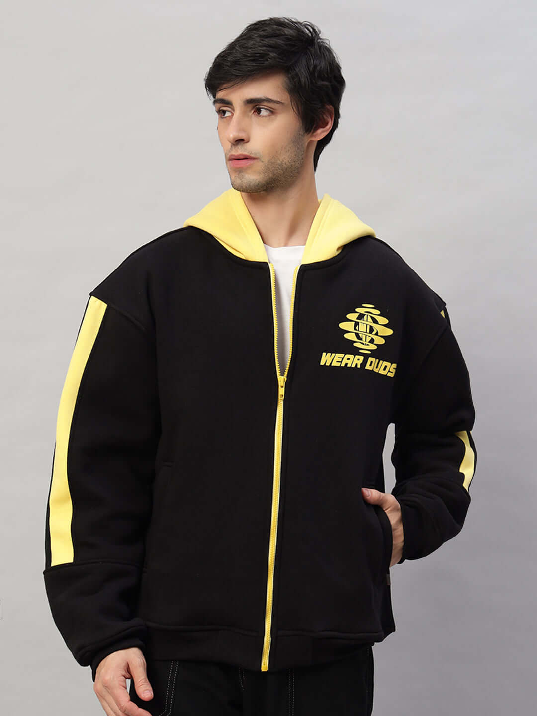 Man wearing Cruiser Fleece Colorblock Hoodie in black and yellow, featuring a zip-up front and stylish design, perfect for casual wear.