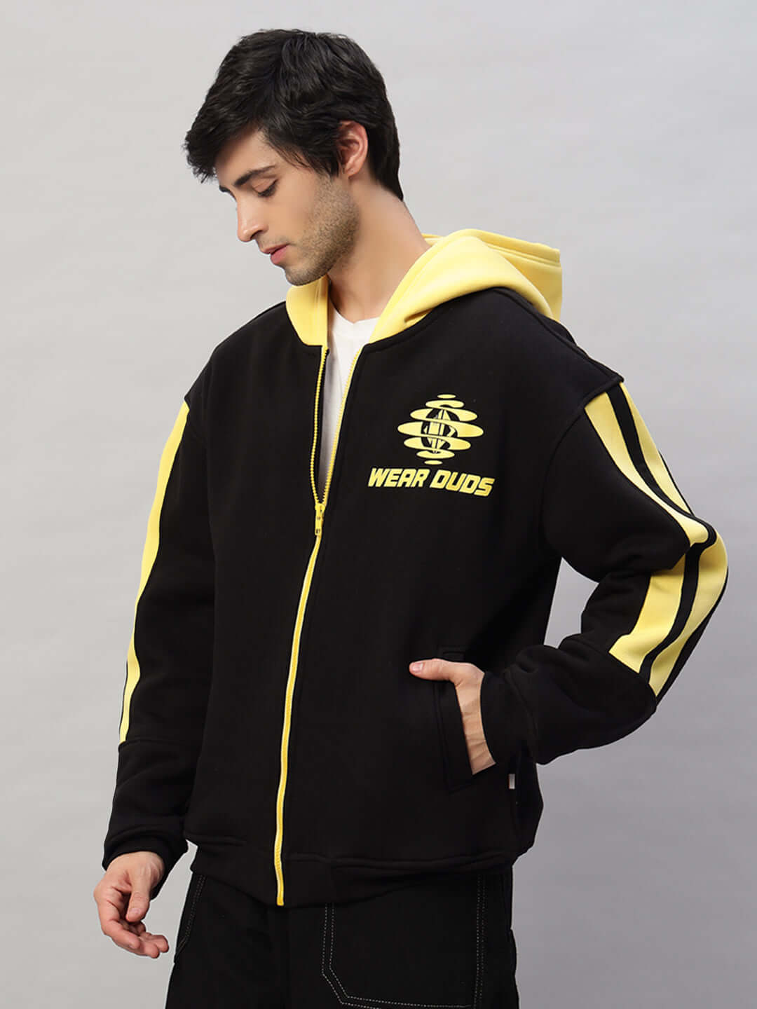 Man wearing Cruiser Fleece Colorblock Hoodie in black and yellow, featuring bold stripes and zipper closure.