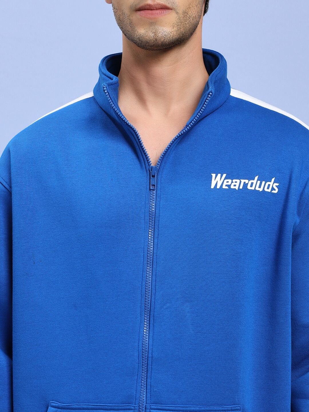 Man wearing RAPID STRIDE ROYAL BLUE COTTON FLEECE CO-ORD SET with zipper detail and brand logo on chest.