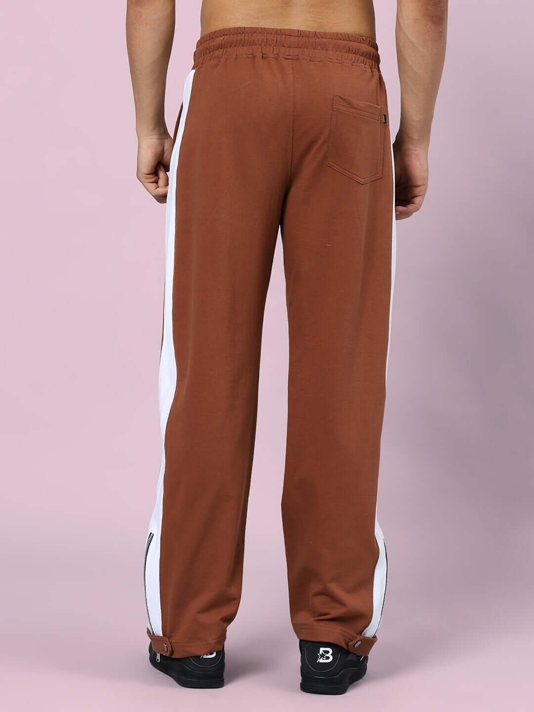 Rear view of brown Wonder Slit Zipper Joggers with white stripes, showcasing comfortable fit and design by DUDS.