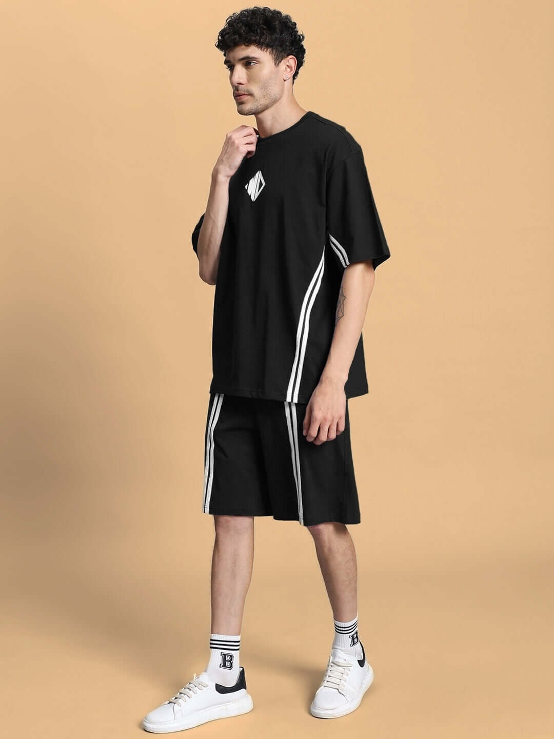 Model wearing black Outlook summer co-ord shorts set with stripes, made from premium cotton French Terry Lycra. Ideal for casual wear.