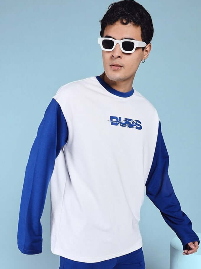 Model wearing Celestine Cool Sweatshirt in white-blue with premium cotton blend, showcased in stylish urban fashion setting.