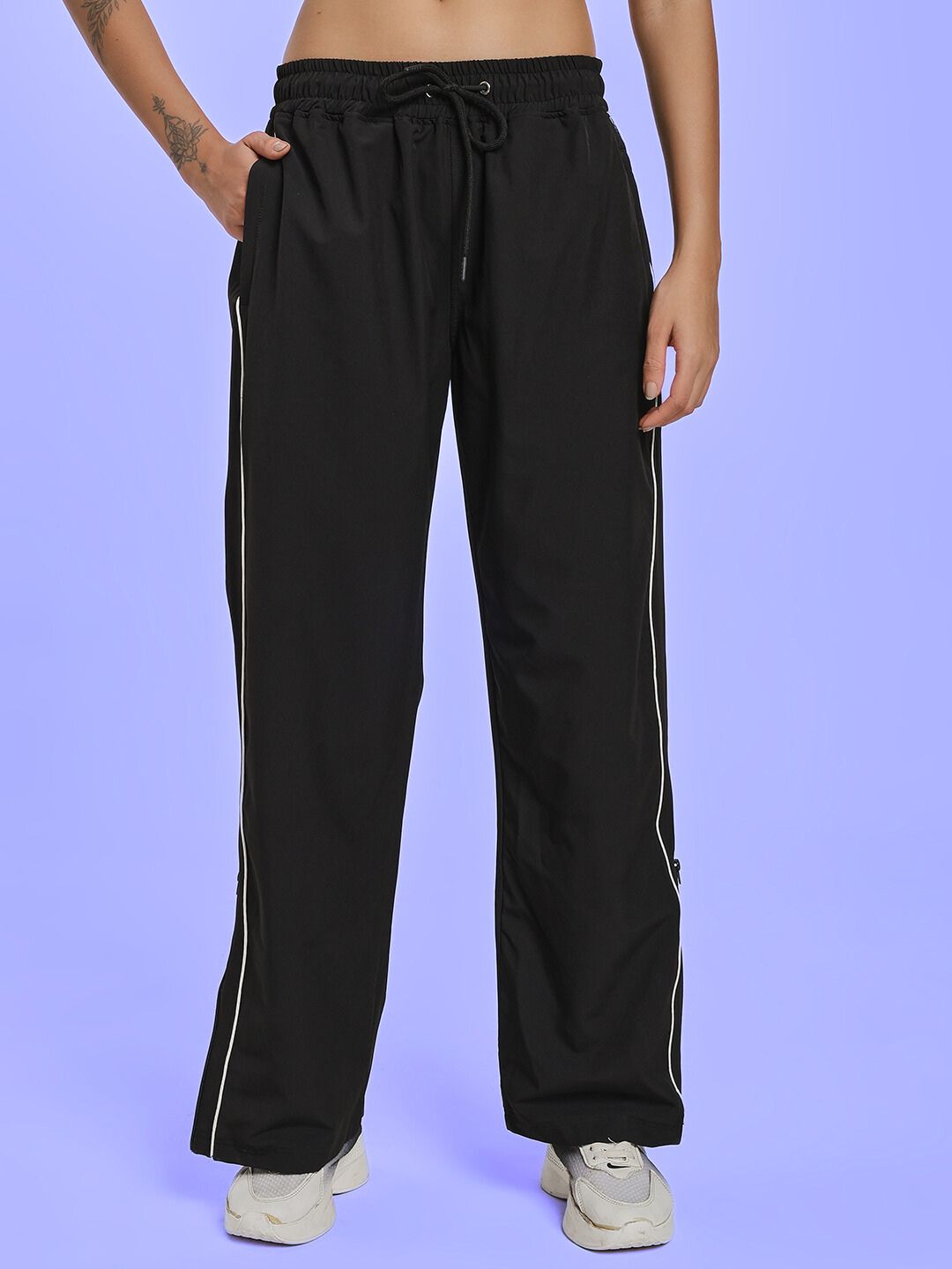 Model wearing WOMEN RELIGHT RELAXED FIT CO-ORD SET BLACK pants, showcasing comfortable loungewear style.