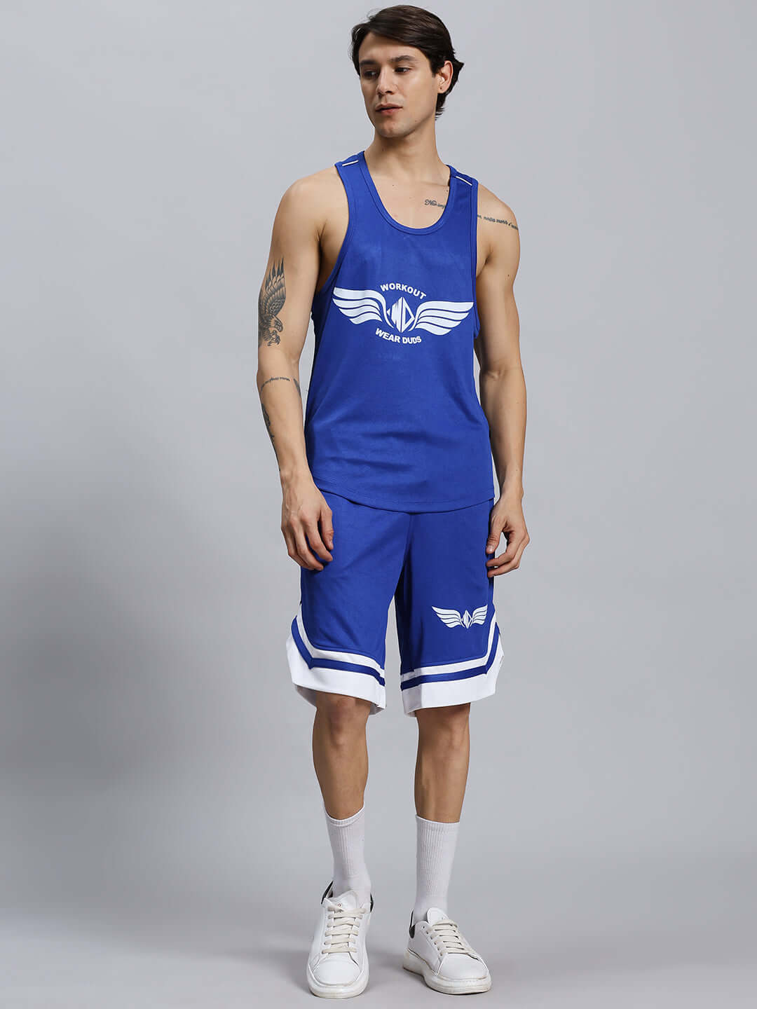 Men's WD Wings Gym Co-ord Set in Royal Blue, featuring sports polyester fabric. Model poses wearing sleeveless top and knee-length shorts.