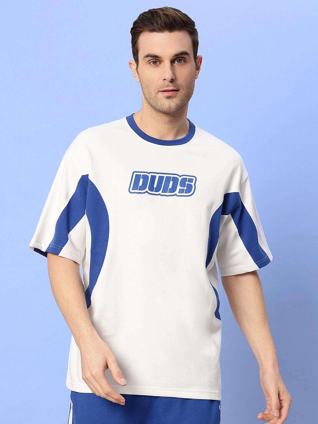 Man wearing EZEL relaxed fit co-ord set in white and blue, featuring a unisex design with premium cotton fabric for comfort.