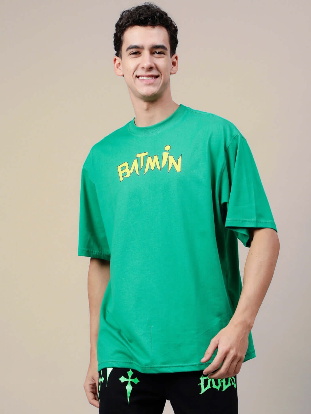 Man wearing BATMIN OVER-SIZED T-SHIRT GREEN, showcasing casual fit.