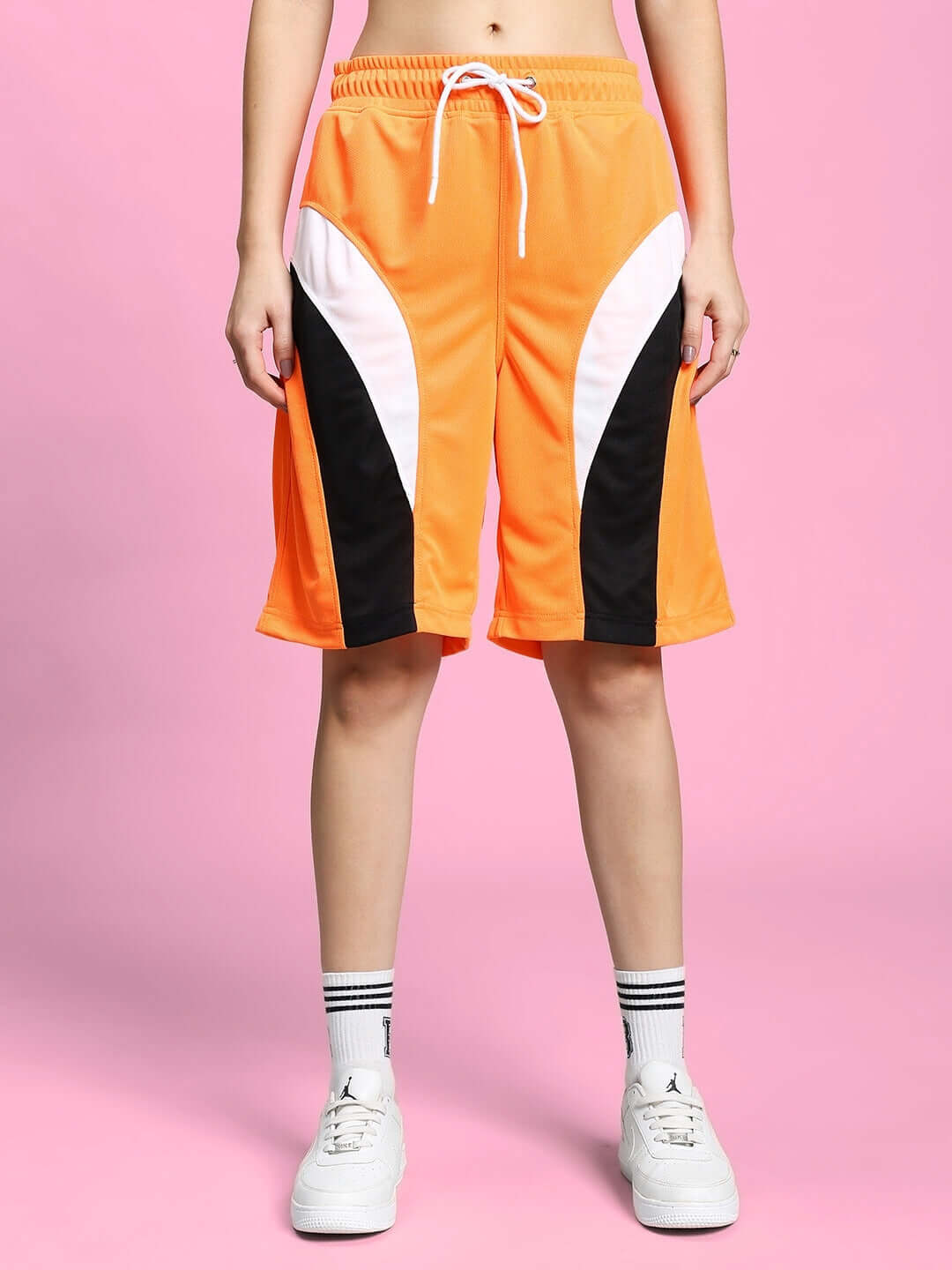 Women's FIFA colorblock co-ord shorts in orange, polyester fabric, sportswear, shown with drawstring, styled for casual comfort.