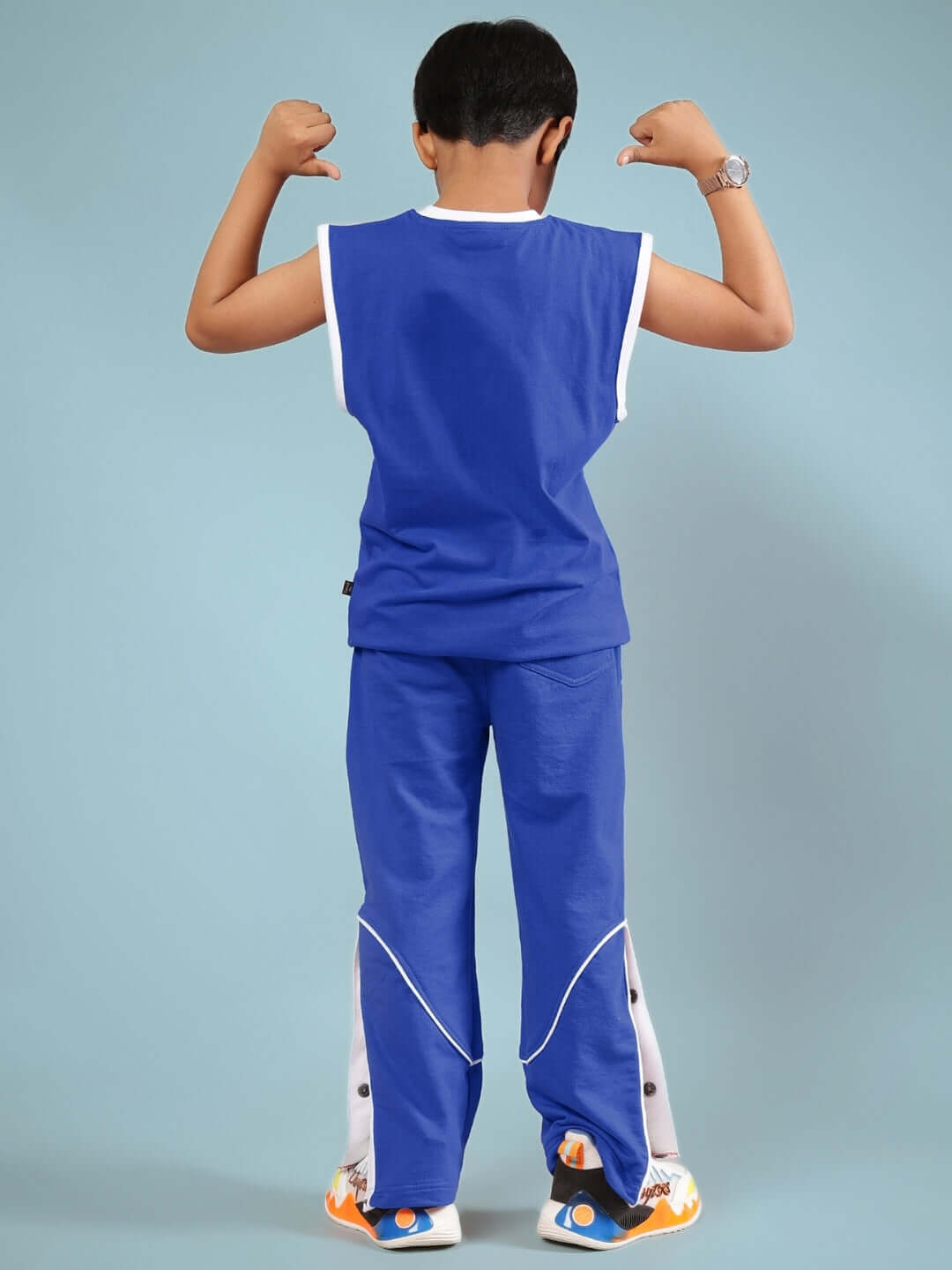 Child modeling blue Washington Huskies co-ord set, showcasing sleeveless top and pants with back view, designed for boys and girls.