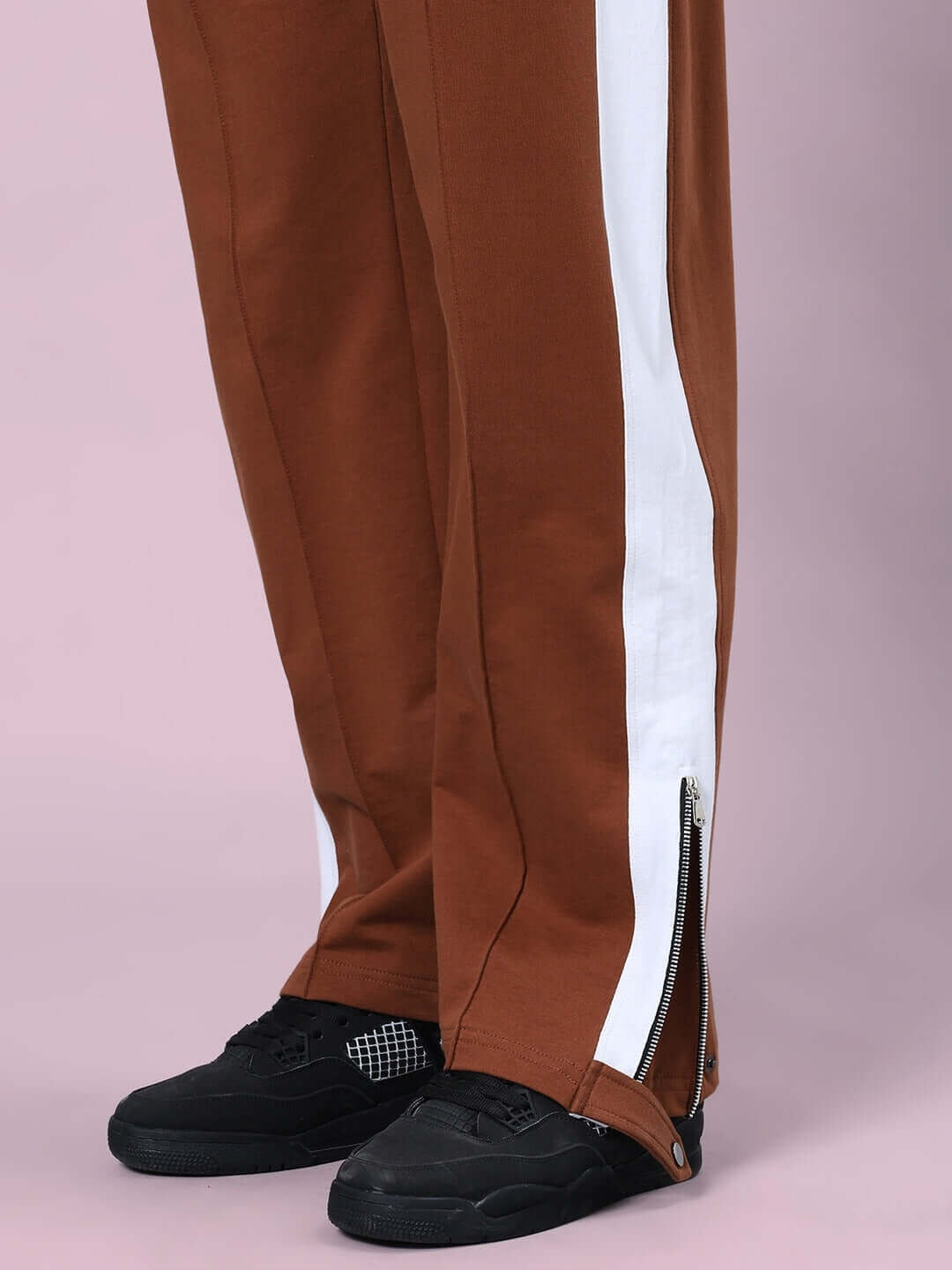 Close-up of brown Wonder Slit Zipper Joggers with side zipper detail, highlighting custom fit option by experienced DUDS tailors.