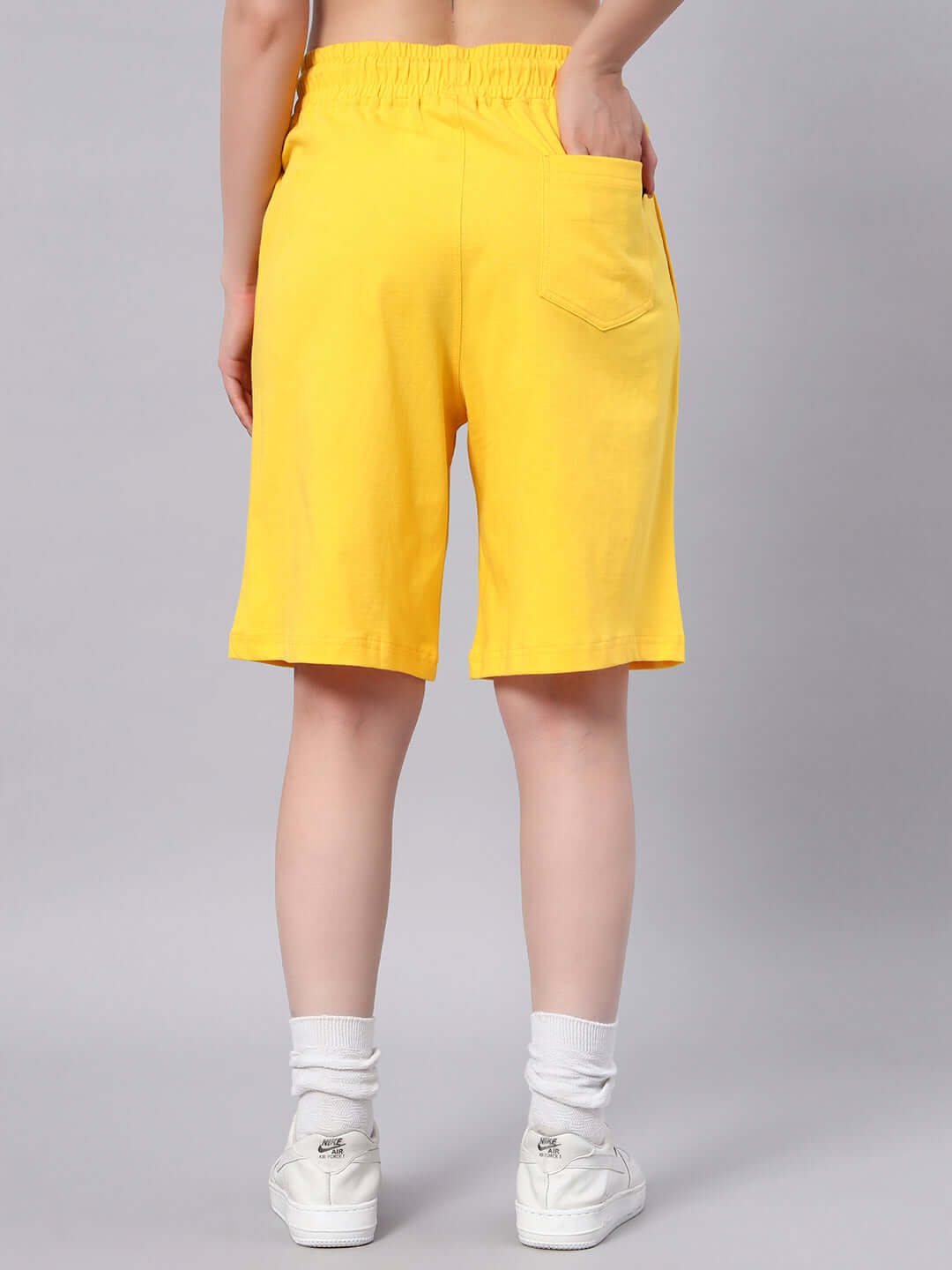 Back view of women's yellow summer Tom & Jerry shorts, featuring a comfortable fit and casual style. Ideal for warm weather.