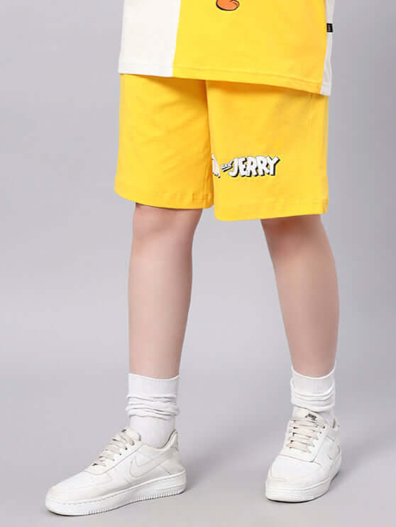 Women's Tom & Jerry yellow summer shorts, featuring a custom fit option for personalized sizing, styled with white sneakers.