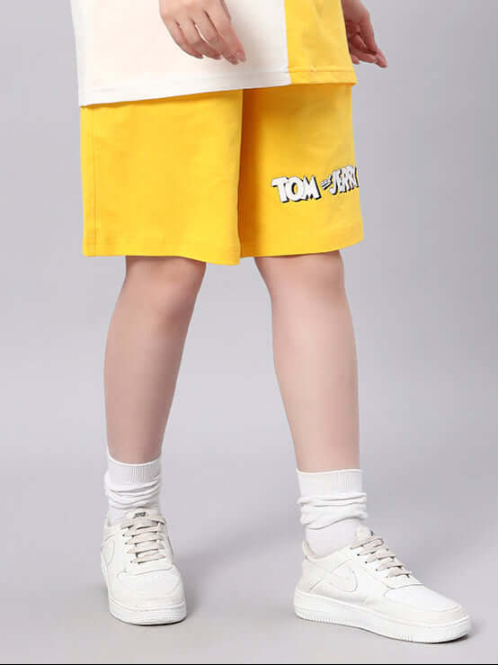 Women's yellow Tom & Jerry summer shorts, customizable size, handmade, worn with white sneakers.