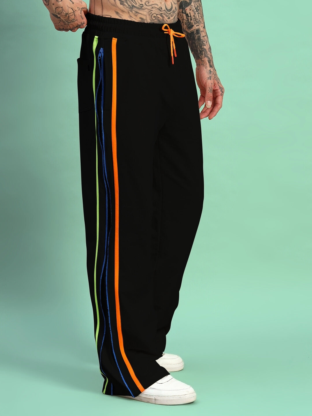 Black joggers with side zipper and colorful stripes, showcased on a model, highlighting modern athletic style and customizable fit.