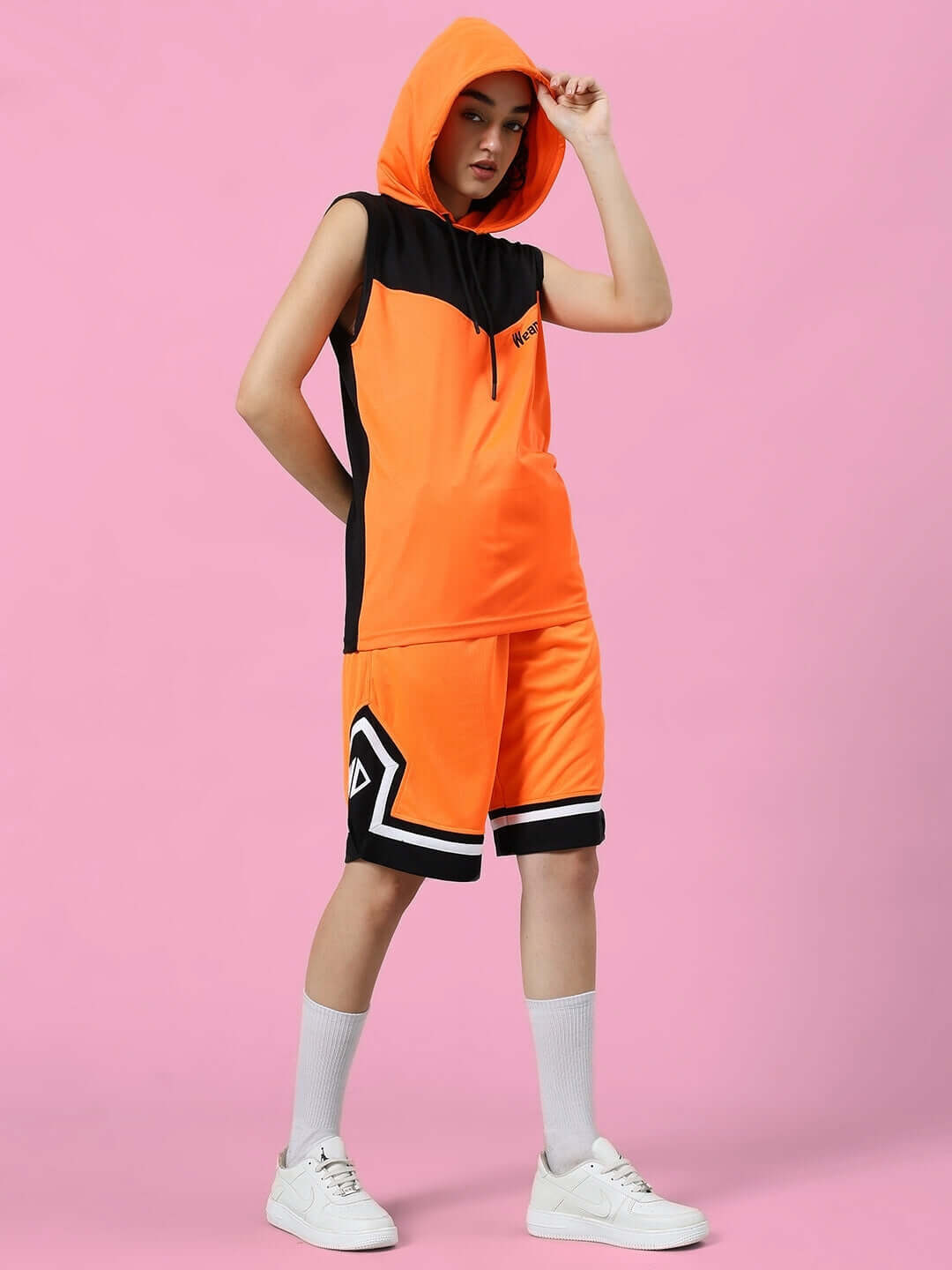 Women's Armado regular fit orange and black shorts, custom fit option available, model wearing hooded top, stylish activewear look