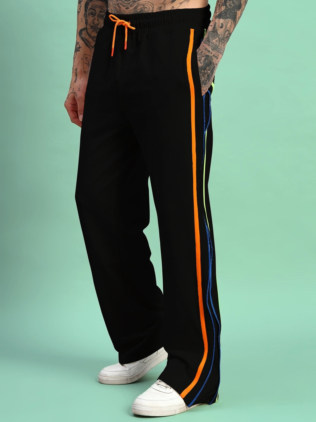 Model wearing Imperial Side Zipper Joggers in black with colorful stripes, showcasing casual style and comfort.