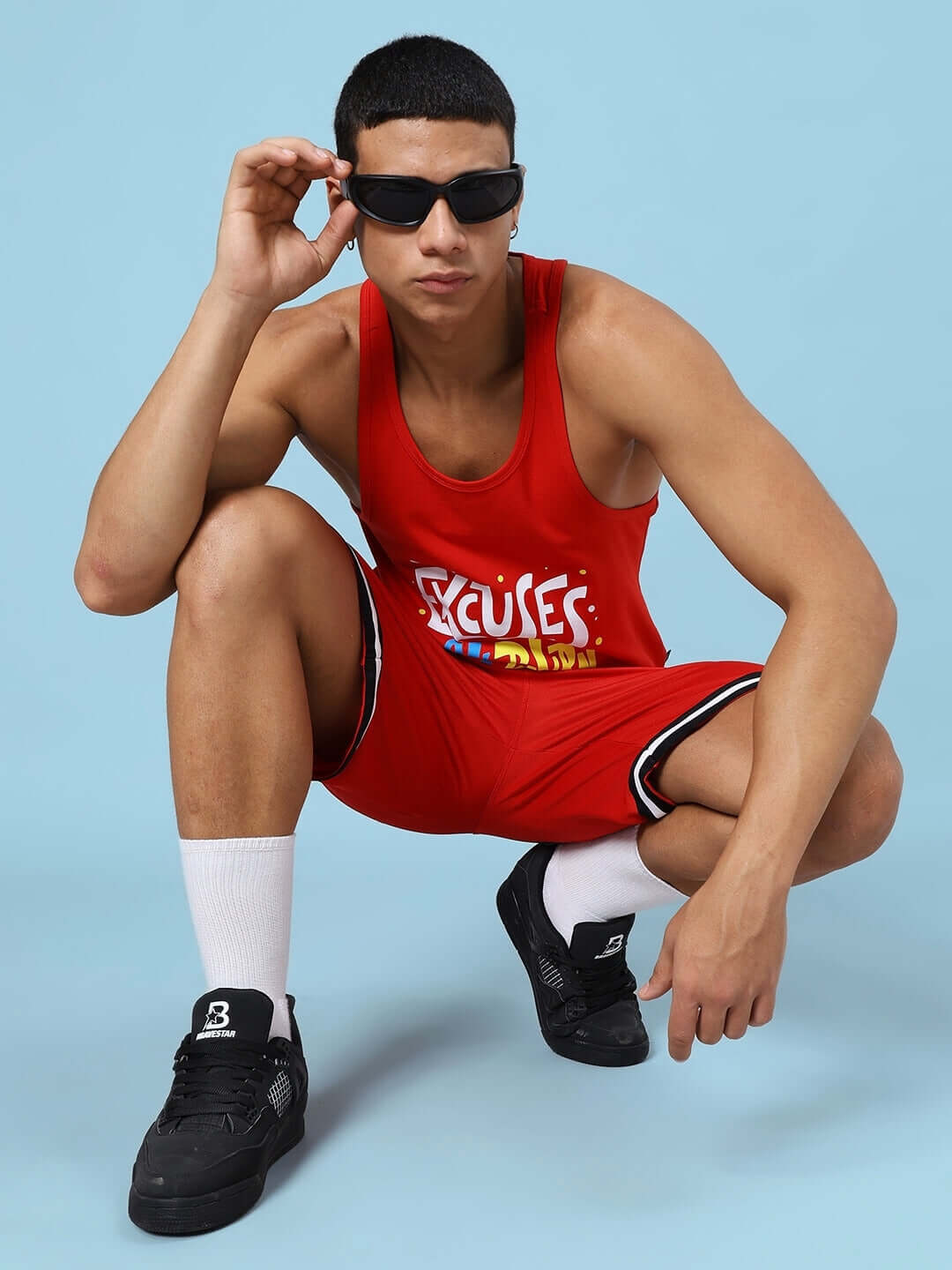 Red "Excuses Don't Burn Calories" gym co-ord set modeled, featuring a sleeveless top and shorts, perfect for fitness enthusiasts.