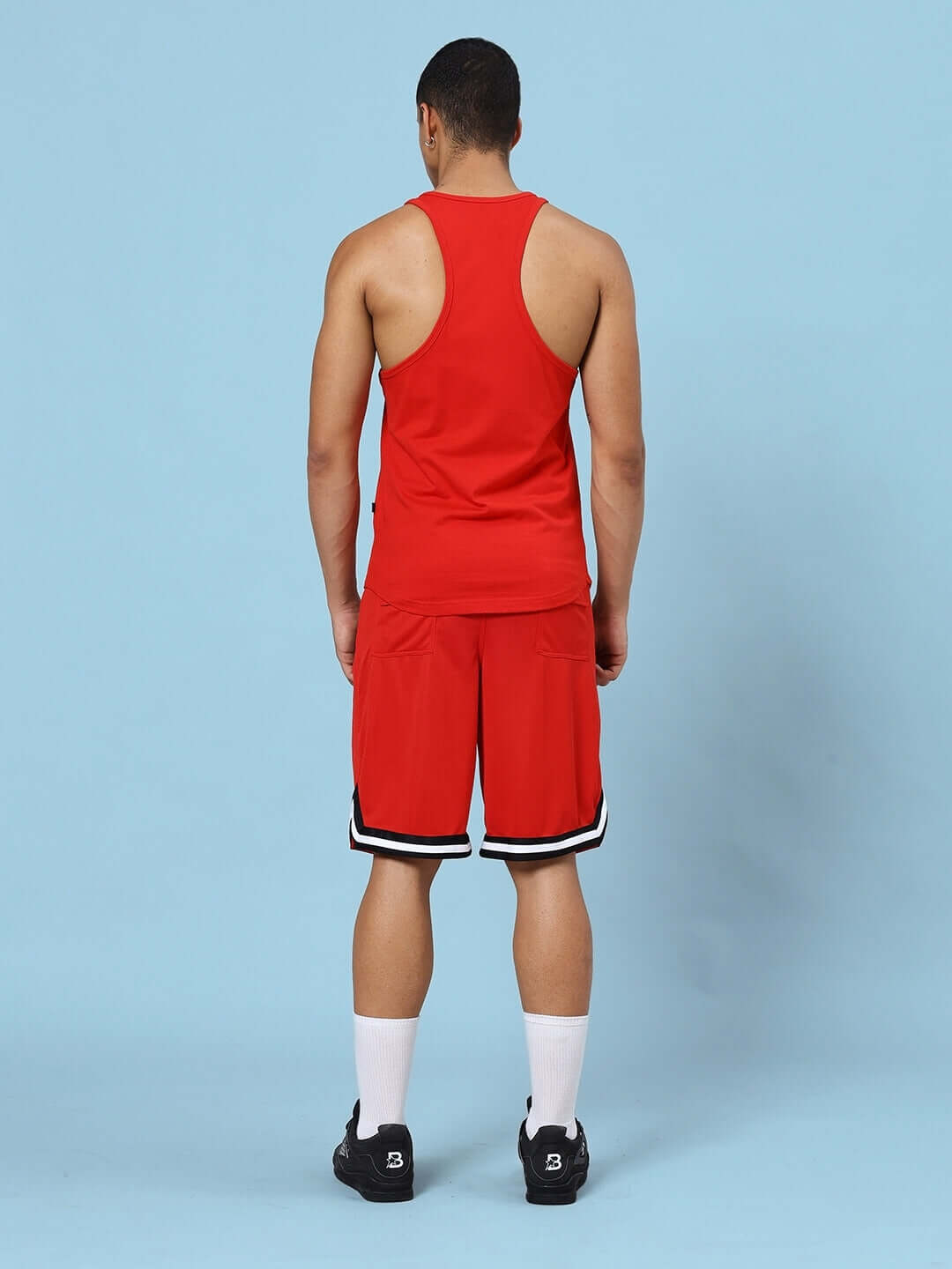 Back view of a red printed gym co-ord set for men, featuring a sleeveless top and shorts, ideal for fitness activities.
